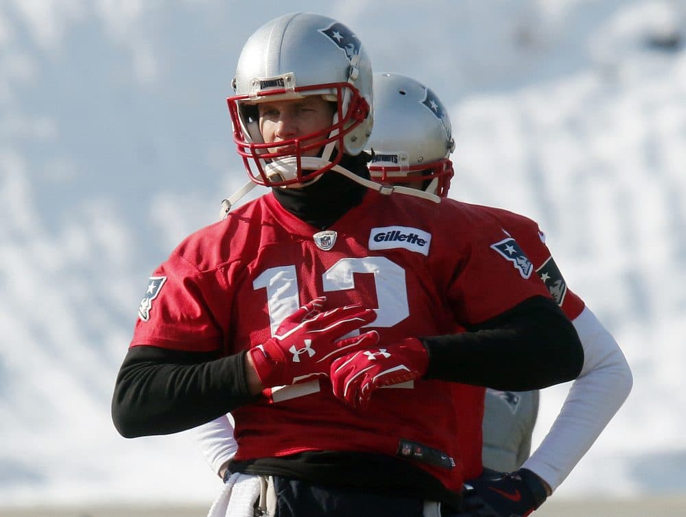 Wearing gloves on both hands, New England Patriots quarterback Tom Brady warms up during an NFL football practice ahead of the AFC Championship on Sunday. (Bill Sikes/AP)