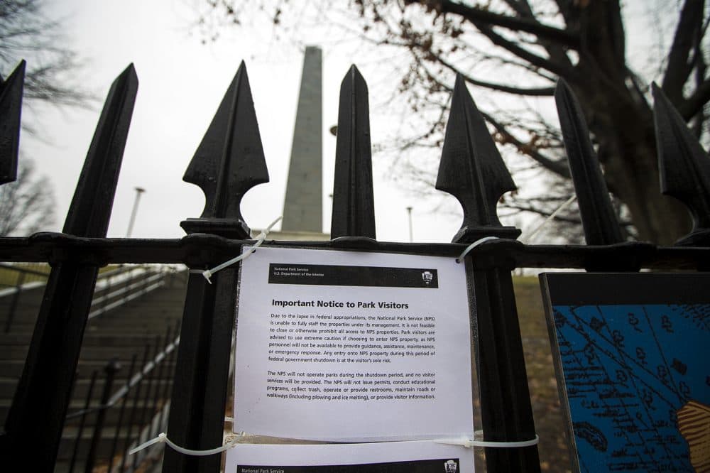 A notice posted outside of one of the gates of Bunker Hill Historic National Park in Charlestown notifying visitors the monument is closed due to the federal government shutdown. (Jesse Costa/WBUR)