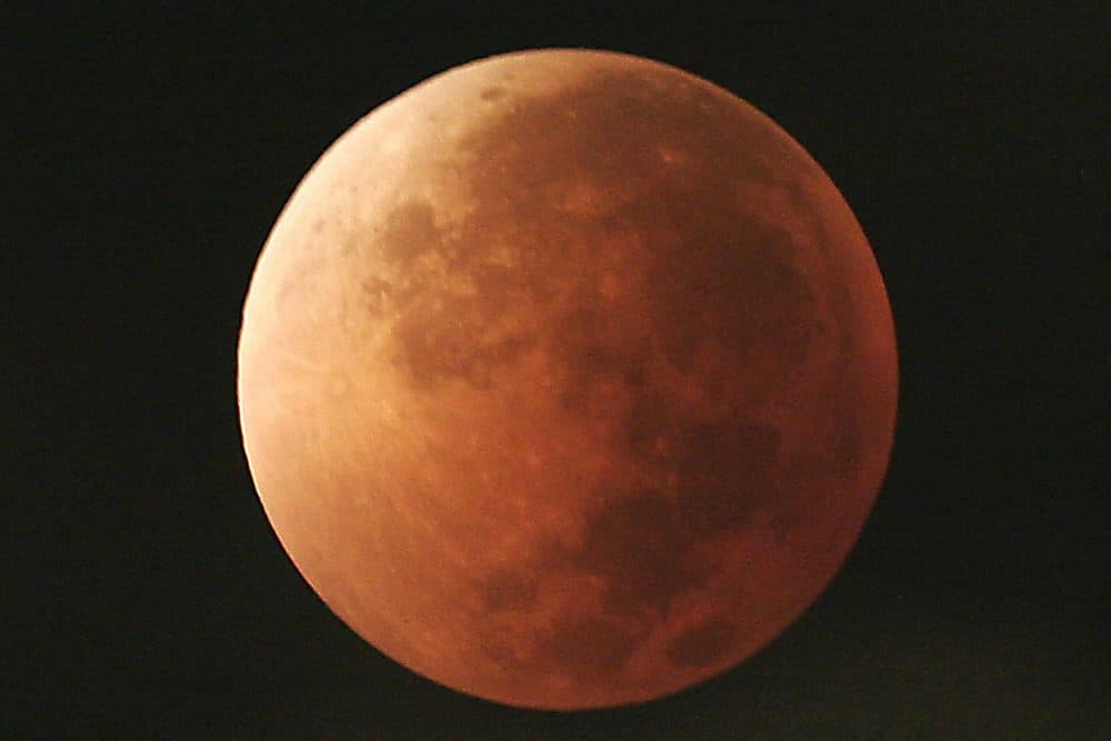 In this Aug. 28, 2007, file photo, the moon takes on different orange tones during a lunar eclipse seen from Mexico City. During a lunar eclipse, the moon's disk can take on a colorful appearance from bright orange to blood red to dark brown and, rarely, very dark gray. On Wednesday, Jan. 31, 2018, a super moon, blue moon and a lunar eclipse will coincide for first time since 1982 and will not occur again until 2037. (Marco Ugarte/AP)