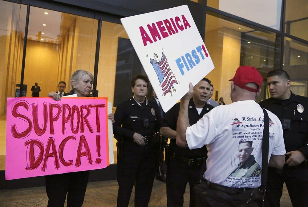 A supporter of President Donald Trump challenges police officers and a Deferred Action for Childhood Arrivals (DACA) program during a rally outside the office of California Democratic Sen. Dianne Feinstein in Los Angeles, Wednesday, Jan. 3, 2018. (Reed Saxon/AP)