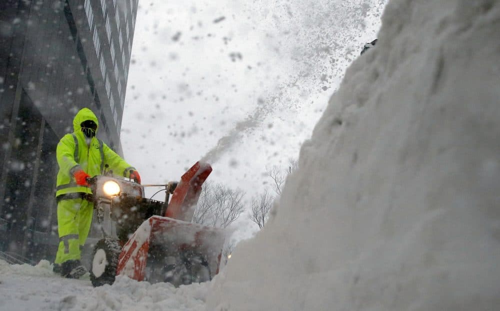 A worker clears the sidewalk in Boston, Thursday, Jan. 4, 2018. A massive winter storm swept from the Carolinas to Maine on Thursday, dumping snow along the coast and bringing strong winds that will usher in possible record-breaking cold. (Michael Dwyer/AP)