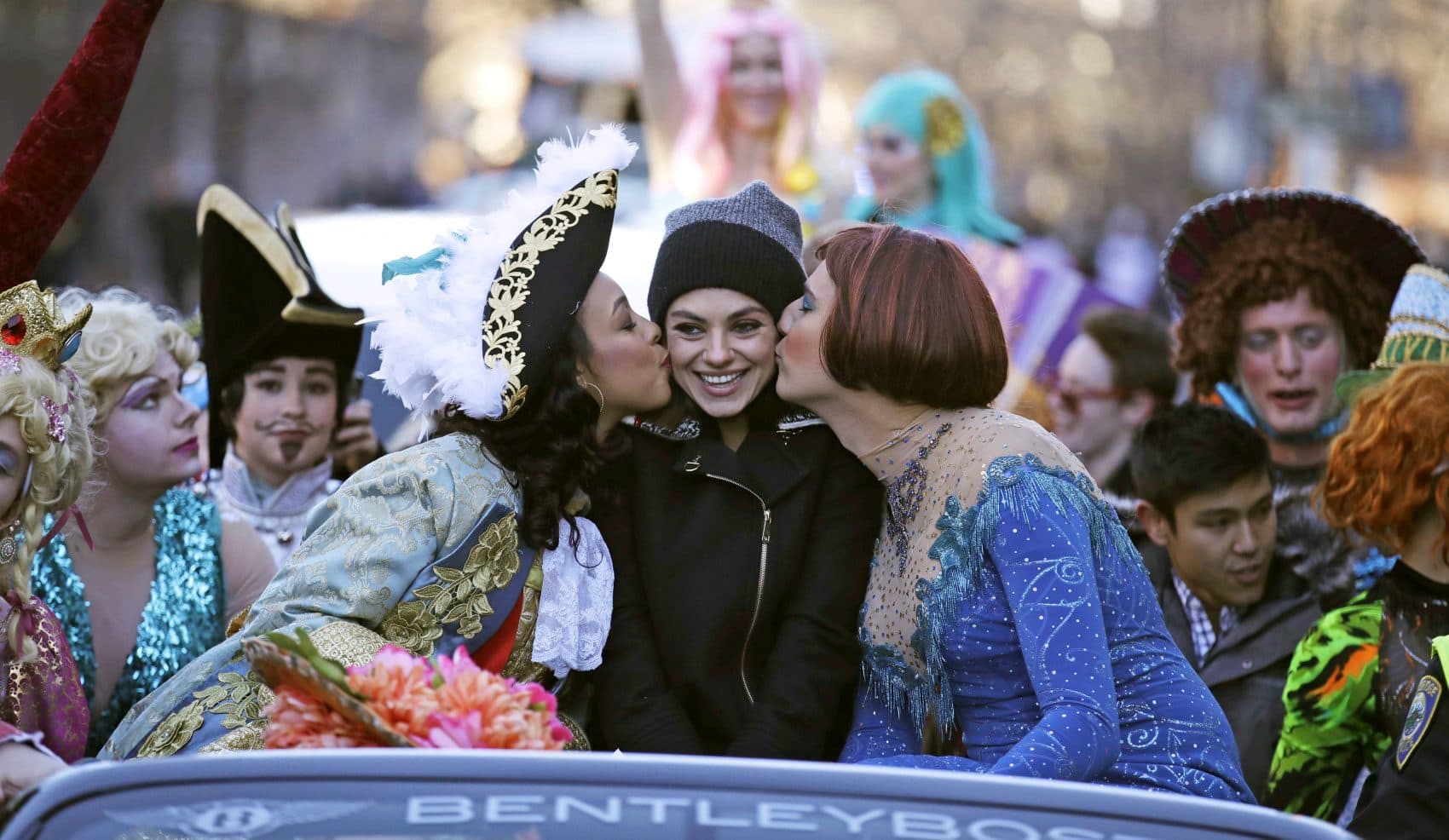 Actress Mila Kunis is kissed by actors dressed in drag during a parade for Kunis in Cambridge, Thursday, Jan. 25, 2018. Kunis was honored as &quot;Woman of the Year&quot; by the Hasty Pudding Theatricals at Harvard University. (Charles Krupa/AP)