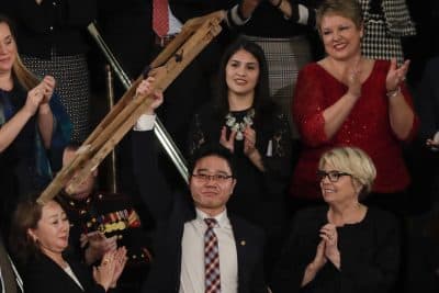 Ji Seong-ho holds up his crutches after his introduction by President Trump during the State of the Union address to a joint session of Congress on Capitol Hill in Washington, Tuesday, Jan. 30, 2018. (J. Scott Applewhite/AP)