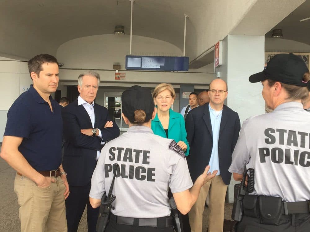 From left, Reps. Seth Moulton and Richard Neal, Sen. Elizabeth Warren and Rep. Jim McGovern meet with Massachusetts State Police troopers who are volunteering with the relief effort in Puerto Rico. (Courtesy McGovern's office)