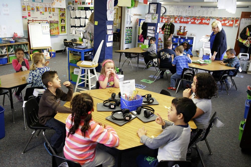 FILE - In this March 10, 2015, file photo, teacher Allison Williams, upper right, works with her kindergarten students at Des Moines Elementary School in Des Moines, Wash. The 2018 legislative session begins on Monday, Jan. 8, 2018, and lawmakers are hoping they'll finish their work including finalizing the last piece of a court mandate on education funding without having to go into overtime. (AP Photo/Ted S. Warren, file)