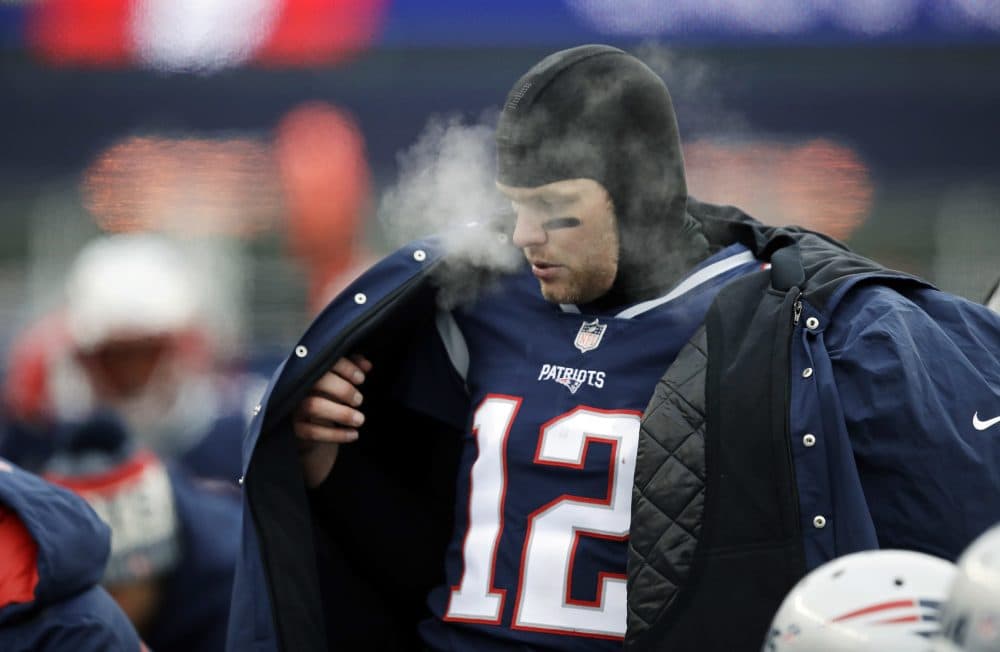 New England Patriots quarterback Tom Brady puts on a coat on the sideline during the first half of an NFL football game against the New York Jets, Sunday, Dec. 31, 2017, in Foxborough, Mass. (AP Photo/Charles Krupa)