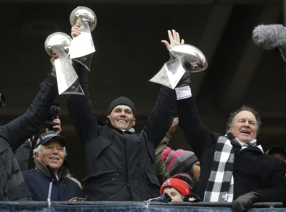 New England Patriots quarterback Tom Brady holds up Super Bowl trophies along with head coach Bill Belichick, right, and team owner Robert Kraft, left, during a rally Tuesday, Feb. 7, 2017, in Boston, to celebrate Sunday's 34-28 win over the Atlanta Falcons in the NFL Super Bowl 51 football game in Houston. (AP Photo/Elise Amendola)
