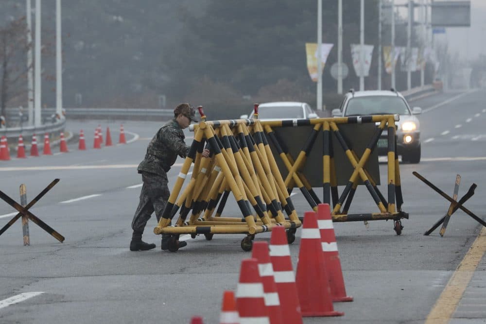 A South Korean soldier adjusts barricade before South Korea's delegation vehicle's arriving at Unification Bridge, which leads to the Panmunjom in the Demilitarized Zone in Paju, South Korea, Monday, Jan. 15, 2018. Officials from the two Koreas met Monday to work out details about North Koreas plan to send an art troupe to the South during next months Winter Olympics, as the rivals tried to follow up on the Norths recent agreement to cooperate in the Games in a conciliatory gesture following months of nuclear tensions. (AP Photo/Lee Jin-man)