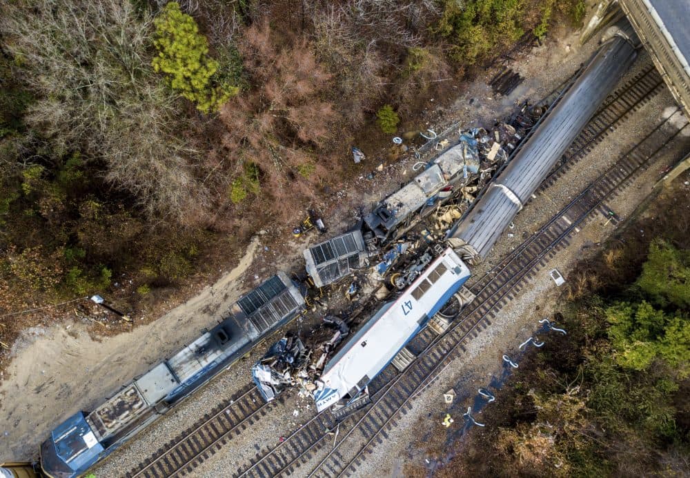 An aerial view of the site of an early morning train crash Sunday, Feb. 4, 2018 between an Amtrak train, bottom right, and a CSX freight train, top left, in Cayce, SC. The Amtrak passenger train slammed into a freight train in the early morning darkness Sunday, killing at least two Amtrak crew members and injuring more than 110 people, authorities said. (Jeff Blake/AP)
