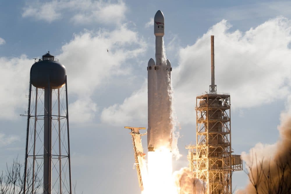 The SpaceX Falcon Heavy launches from Pad 39A at the Kennedy Space Center in Florida, on Feb. 6, 2018, on its demonstration mission. The world's most powerful rocket blasted off Tuesday on its highly anticipated maiden test flight, carrying CEO Elon Musk's cherry red Tesla roadster to an orbit near Mars. (Jim Watson/AFP/Getty Images)