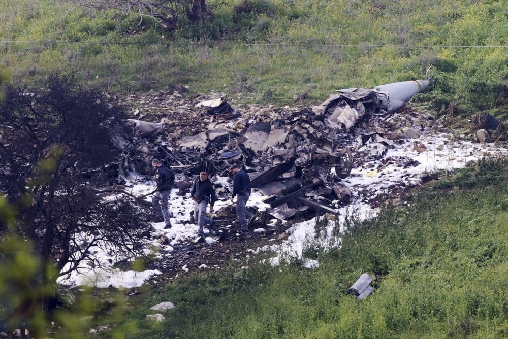 Israeli security stands around the wreckage of an F-16 that crashed in northern Israel, near kibbutz of Harduf, Saturday, Feb. 10, 2018. The Israeli military shot down an Iranian drone it said infiltrated the country early Saturday before launching a &quot;large-scale attack&quot; on at least a dozen Iranian and Syrian targets inside Syria, in its most significant engagement since the fighting in neighboring Syria began in 2011. Responding anti-aircraft fire led to the downing of an Israeli fighter plane. (Rami Slush/AP)