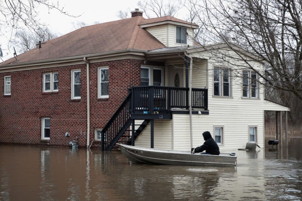 A resident uses a rowboat to navigate a flooded neighborhood on Feb. 22, 2018 in Lake Station, Ind. Heavy rains and snow melt have caused flooding in Indiana, Illinois, Michigan, Wisconsin and other Midwest states. (Scott Olson/Getty Images)