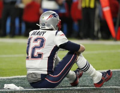 New England Patriots' Tom Brady sits on the field after the NFL Super Bowl 52 football game against the Philadelphia Eagles Sunday, Feb. 4, 2018, in Minneapolis. The Eagles won 41-33. (AP Photo/Charlie Neibergall)