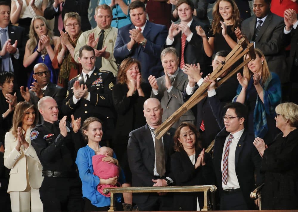 Ji Seong-ho, right, holds up his crutches after being acknowledge by President Donald Trump during Trump's address to a joint session of Congress on Capitol Hill in Washington, Tuesday, Jan. 30, 2018. (Pablo Martinez Monsivais/AP)