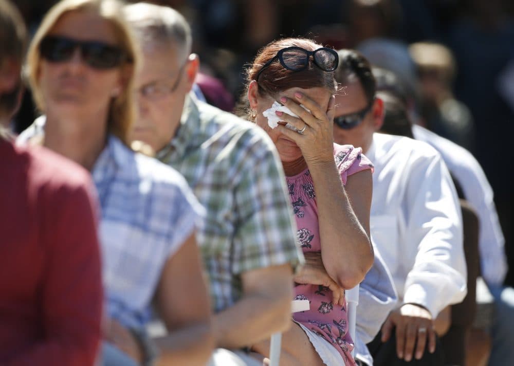 Attendees react at a prayer vigil for the victims of the shooting at Marjory Stoneman Douglas High School at the Parkland Baptist Church, Thursday, Feb. 15, 2018 in Parkland, Fla.  Nikolas Cruz, a former student, was charged with 17 counts of premeditated murder Thursday morning. (AP Photo/Wilfredo Lee)