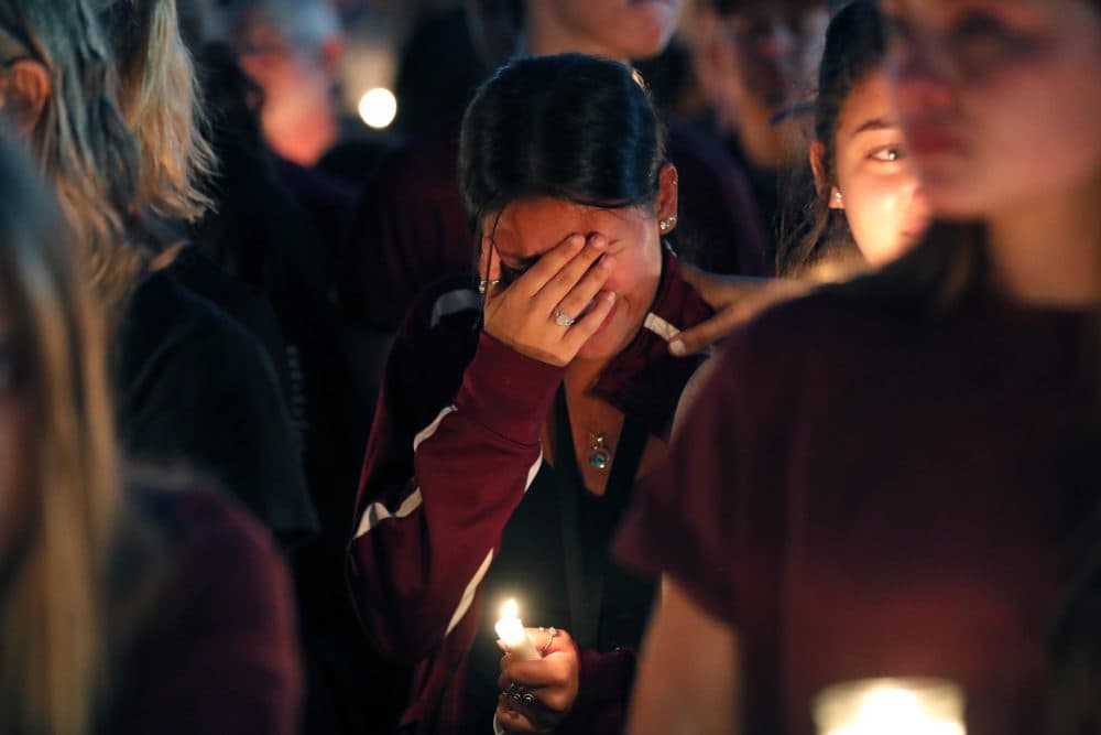 A woman cries during a candlelight vigil for the victims of the Wednesday shooting at Marjory Stoneman Douglas High School, in Parkland, Fla., Thursday, Feb. 15, 2018.  (Gerald Herbert/AP)