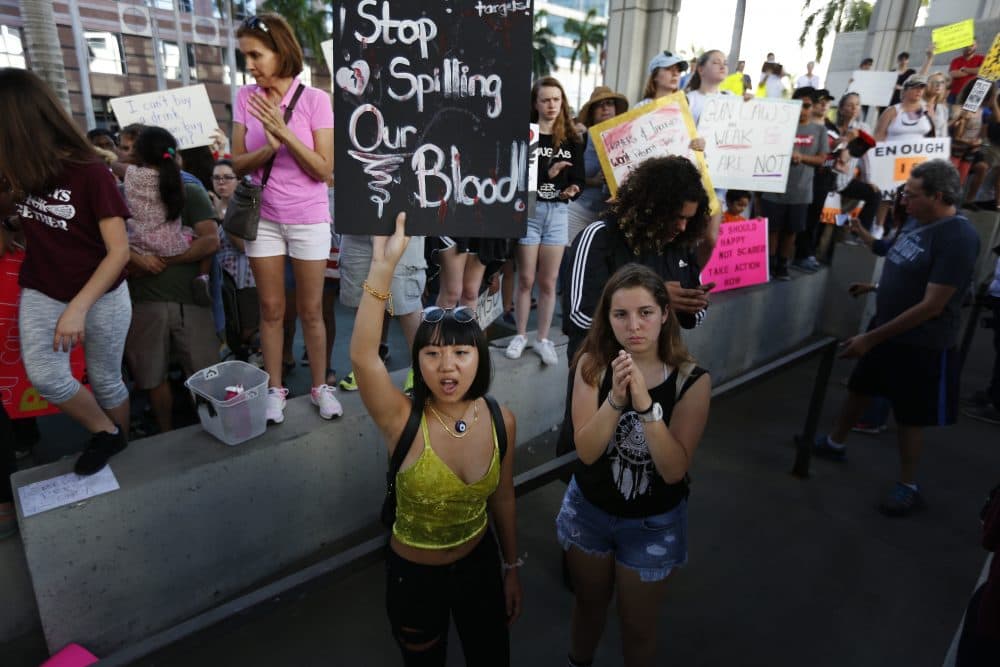 Marylene Dinliana, 18, holds a sign that reads, &quot;Stop Spilling Our Blood&quot; during a protest against guns on the steps of the Broward County Federal courthouse in Fort Lauderdale, Fla., on Saturday, Feb. 17, 2018. Nikolas Cruz, a former student, shot and killed 17 people at Marjory Stoneman Douglas High School, earlier in the week. (Brynn Anderson/AP)