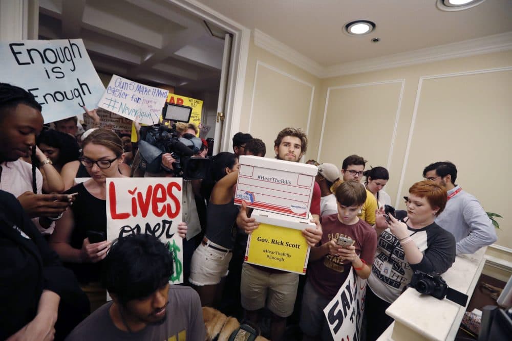 People crowd the entrance to the office of Florida Gov. Rick Scott with boxes of petitions for gun control reform, after a rally on the steps of the state Capitol in Tallahassee, Fla., Wednesday. Seventeen students and teachers were killed last Wednesday in a mass shooting at Marjory Stoneman Douglas High School in Parkland, Fla. (Gerald Herbert/AP)