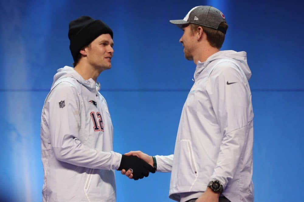 Patriots QB Tom Brady and Eagles QB Nick Foles share pleasantries earlier this week. (Getty Images)