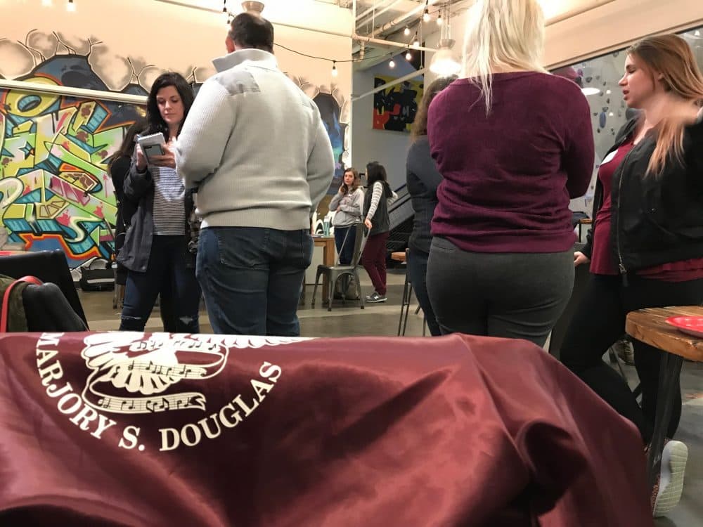 Alumni of the Marjory Stoneman Douglas High School in Parkland, Florida, are organizing groups across the country to support the #NeverAgain movement. A group met here in Somerville. (Carrie Jung/WBUR)