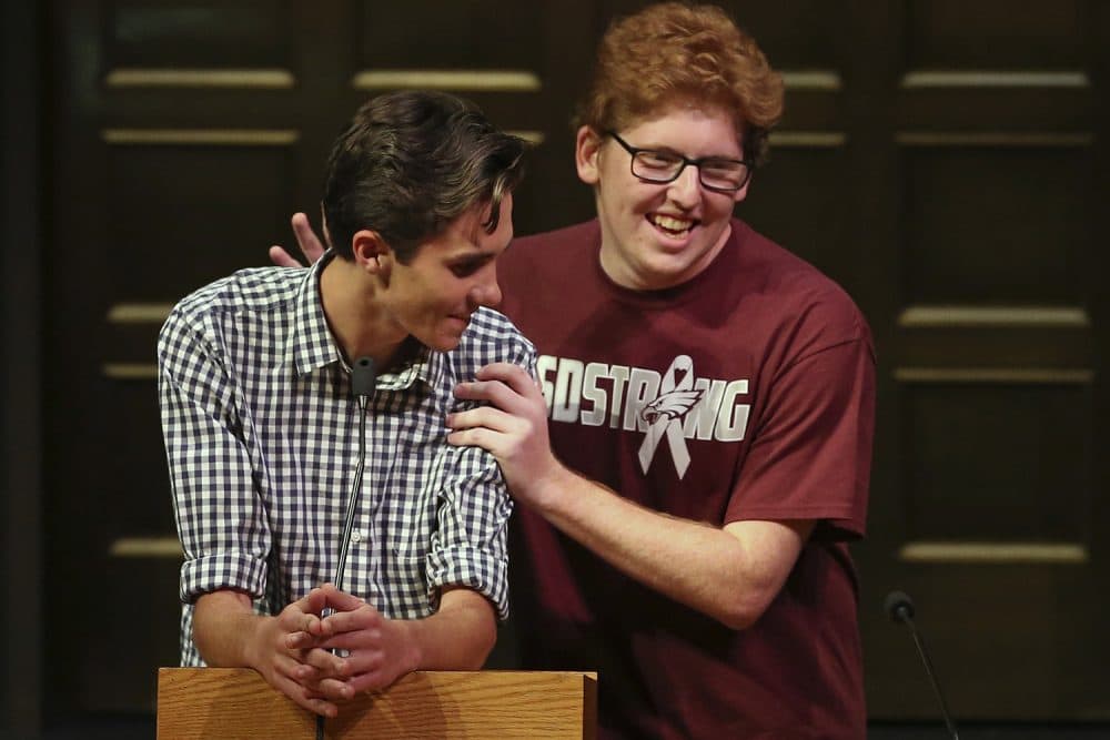 David Hogg, gets a pat on the back from Matthew Deitsch, as student survivors from Marjory Stoneman Douglas High School in Parkland, Fla. addresses a community rally for common sense gun legislation at Temple B'nai Abraham Sunday, Feb. 25, 2018, in Livingston, N.J. Speakers include survivors Hogg, Deitsch and his brother Matthew Deitsch. (Rich Schultz/AP)