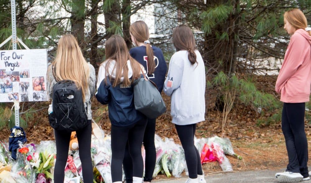 Students gather outside the memorial to two Needham High juniors. (Max Larkin/WBUR)