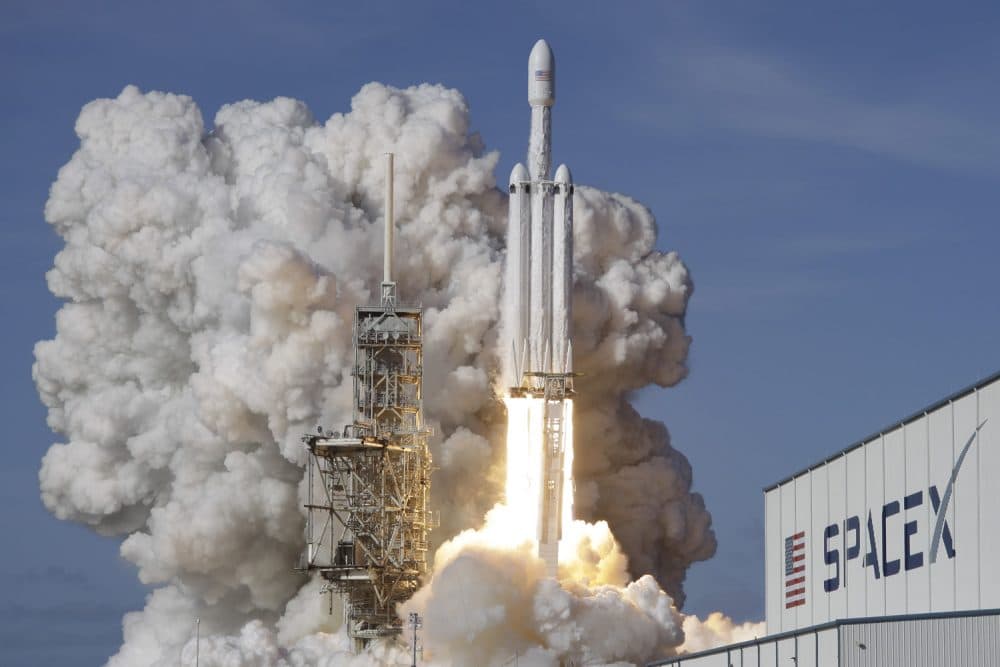 A Falcon 9 SpaceX heavy rocket lifts off from pad 39A at the Kennedy Space Center in Cape Canaveral, Fla., Tuesday, Feb. 6, 2018. The Falcon Heavy, has three first-stage boosters, strapped together with 27 engines in all. (AP Photo/John Raoux)