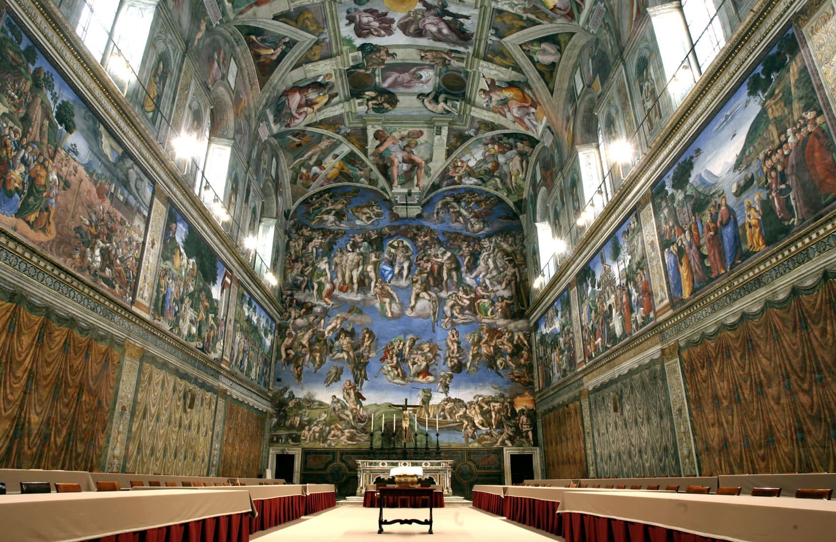 In this April 16, 2005 file photo, tables and chairs line the Sistine Chapel at the Vatican in preparation for the conclave. Five centuries after Michelangelo's ceiling frescoes were inaugurated at the Sistine Chapel, at least 10,000 people visit the site each day, raising concerns about temperature, dust and humidity affecting the famed art. But a Vatican Museums official said in the Vatican newspaper Wednesday, Oct. 31, 2012 that there are no plans to try to limit tourists' access. (Pier Paolo Cito/AP Photo)
