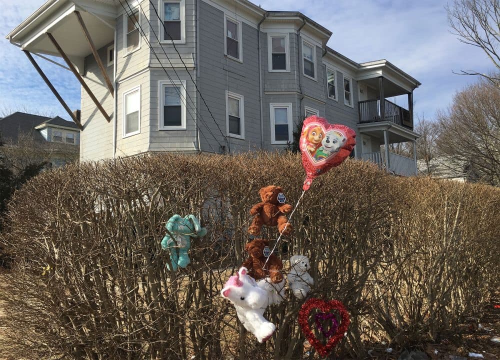 Balloons and stuffed animals are left outside 247 Prospect St., in Brockton, where the slain children were found. (Bruce Gellerman/WBUR)