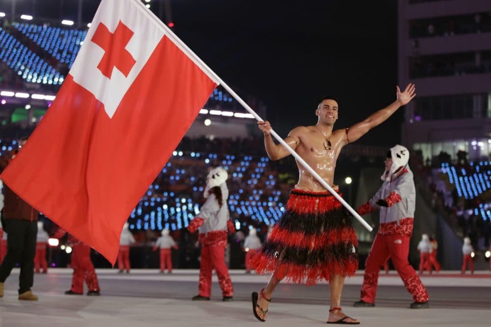 Pita Taufatofua carries the flag of Tonga during the opening ceremony of the 2018 Winter Olympics in Pyeongchang, South Korea, Friday, Feb. 9, 2018. (AP Photo/Vadim Ghirda)