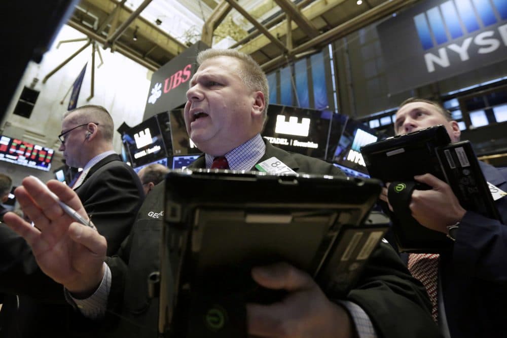 Trader George Ettinger, center, works on the floor of the New York Stock Exchange, Tuesday, Feb. 6, 2018. The Dow Jones industrial average fell as much as 500 points in early trading, bringing the index down 10 percent from the record high it reached on Jan. 26. The DJIA quickly recovered much of that loss. (AP Photo/Richard Drew)