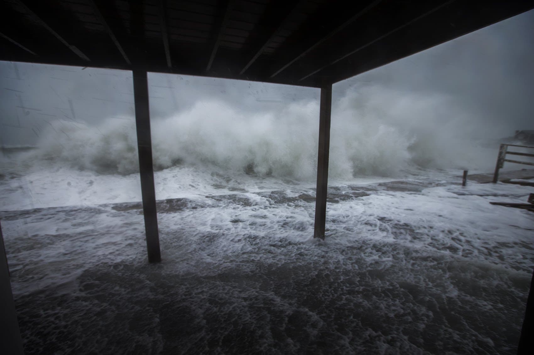 Waves crash along the seawall on Turner Road in Scituate. (Jesse Costa/WBUR)