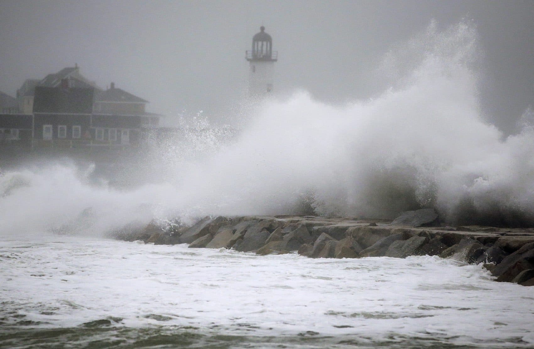 Waves crash against a seawall near the Scituate Lighthouse on Friday in Scituate. (Steven Senne/AP)