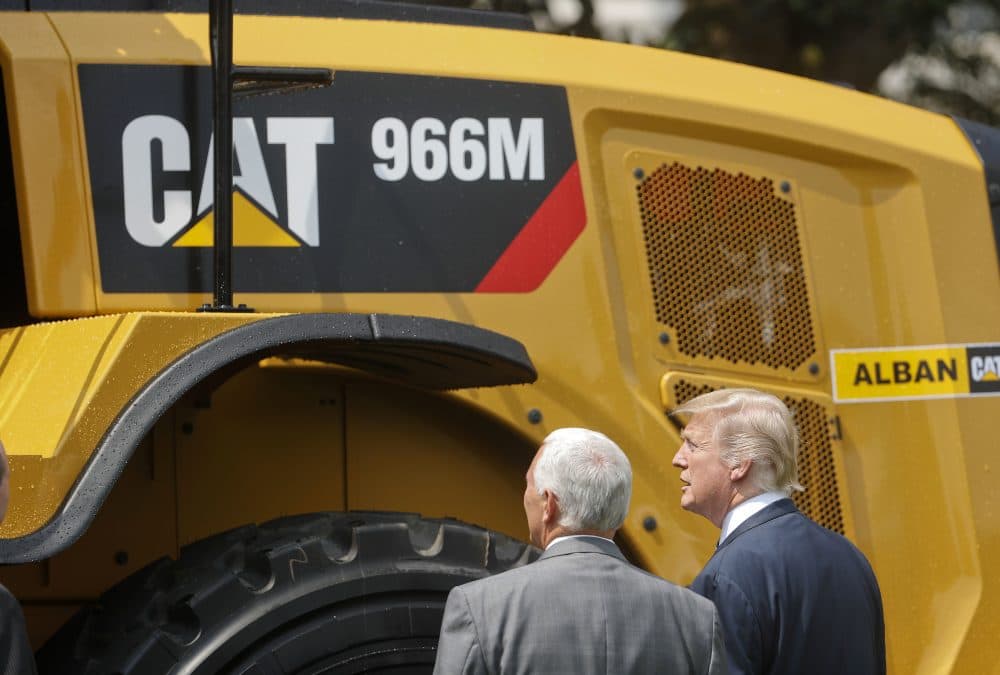 President Trump and Vice President Mike Pence stop to looks at a Caterpillar truck, manufactured in Illinois, on the South Lawn of the White House in Washington, Monday, July 17, 2017, during a &quot;Made in America,&quot; product showcase featuring items created in each of the U.S. 50 states. (Pablo Martinez Monsivais/AP)