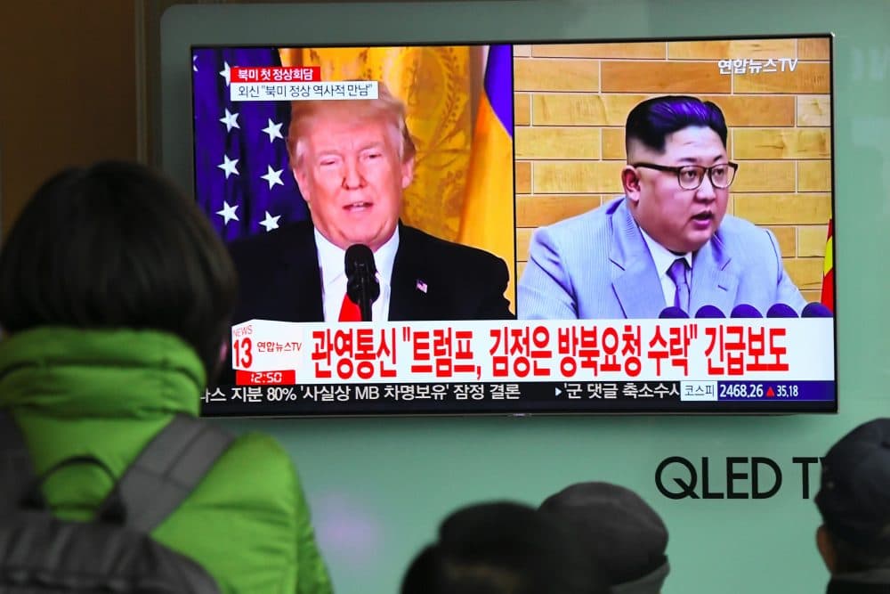 People watch a television news report showing pictures of President Trump and North Korean leader Kim Jong Un at a railway station in Seoul on March 9, 2018. (Jung Yeon-je/AFP/Getty Images)