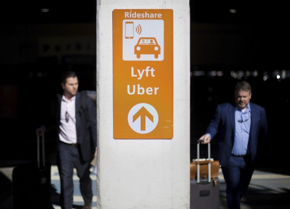 A sign directs Lyft and Uber riders to a designated pickup location at Hartsfield-Jackson Atlanta International Airport in Atlanta, Wednesday, Jan. 31, 2018. (David Goldman/AP)