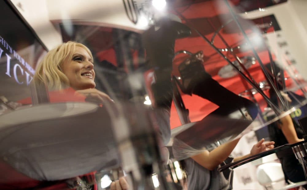 Adult film star Stormy Daniels, left, signs autographs at the AVN Adult Entertainment Expo in Las Vegas, Sunday, Jan. 11, 2009. (Jae C. Hong/AP)