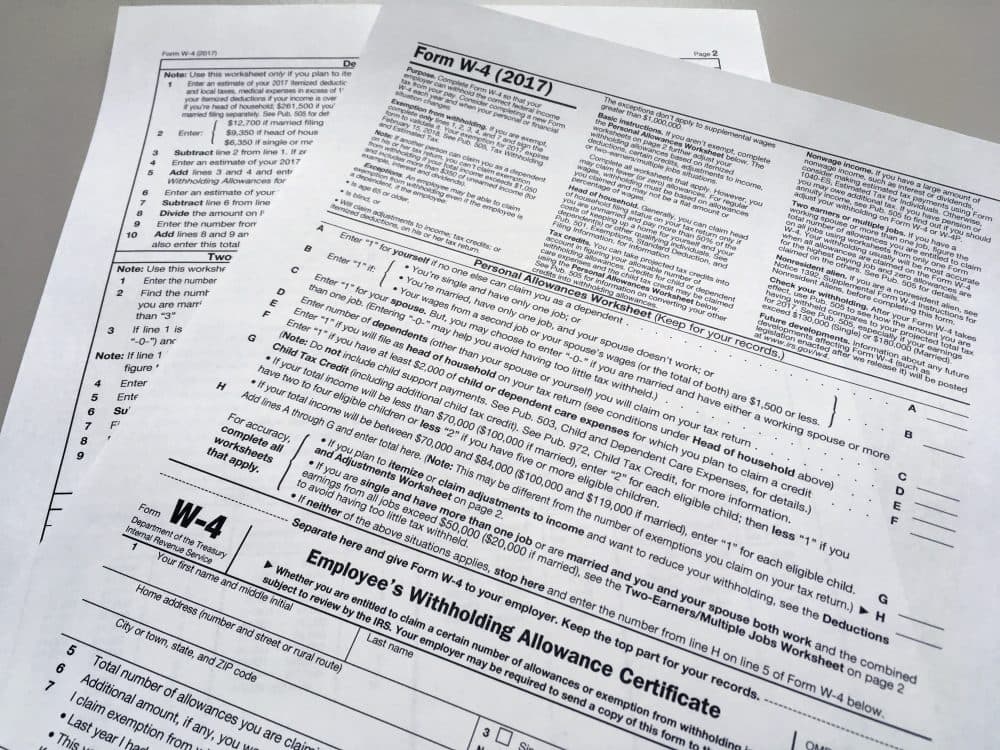 This photo shows an IRS W-4 form on Thursday, Feb. 1, 2018, in New York. Workers are starting to see more take-home pay as employers implement the new withholding guidelines from the IRS. How much extra cash depends on several factors, such as workers' income, how often they are paid and the number of withholdings allowances they claim on their IRS Form W-4 with their employer. (AP Photo/Barbara Woike)