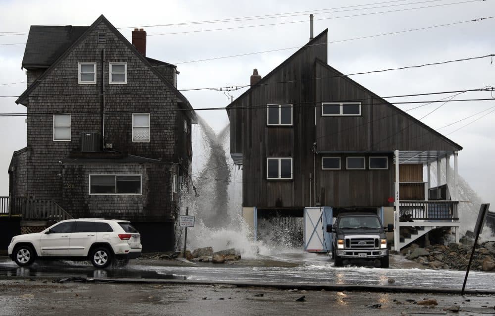 Ocean water pours off the roofs of these beachfront homes, Tuesday, March 6, 2018, as high surf continues in Marshfield, Mass. Utilities are racing to restore power to tens of thousands of customers in the Northeast still without electricity after last week's storm as another nor'easter threatens the hard-hit area with heavy, wet snow, high winds, and more outages. (Elise Amendola/AP)