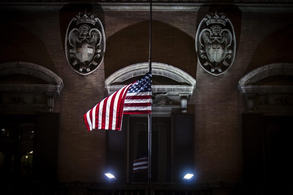 The American flag flies at half staff Dec. 15, 2012, to mourn the victims of the Newtown, Connecticut, school shooting, at the US Embassy in Rome. (Angelo Carconi/AP)