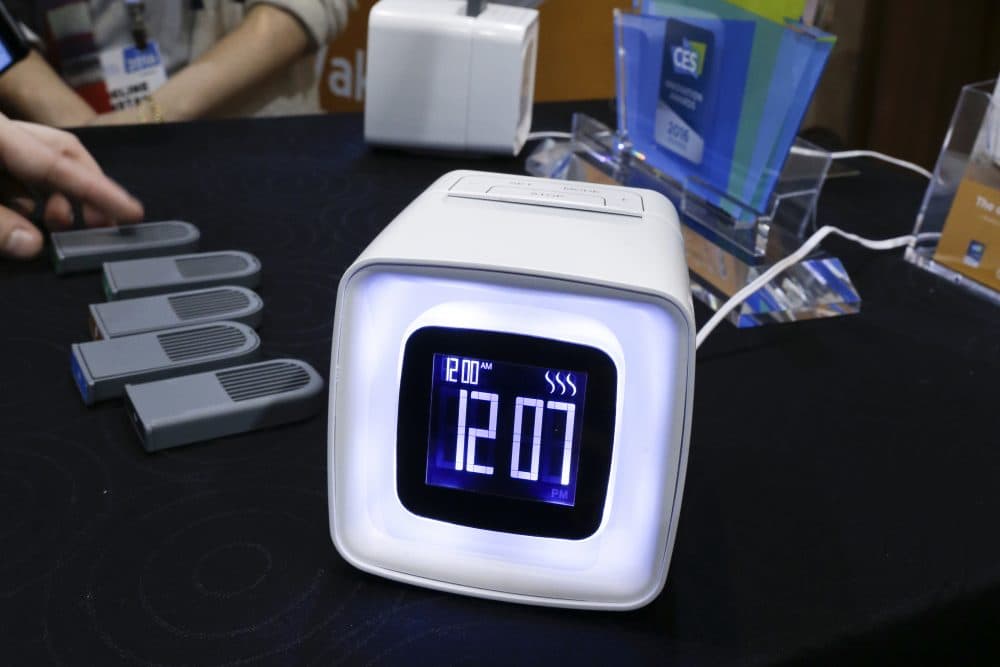 In this Monday, Jan. 4, 2016, photo, Sensorwake olfactory alarm is displayed at CES Unveiled, a media preview event for CES International in Las Vegas. The device by the French company emits scents that should get you up gently in about two minutes. The clock, selling for a promotional $89 during CES, diffuses particles contained in packets with dry air to give you a whiff of things like espresso, hot croissants, a lush jungle, chocolate or pepper mint. (AP Photo/Gregory Bull)