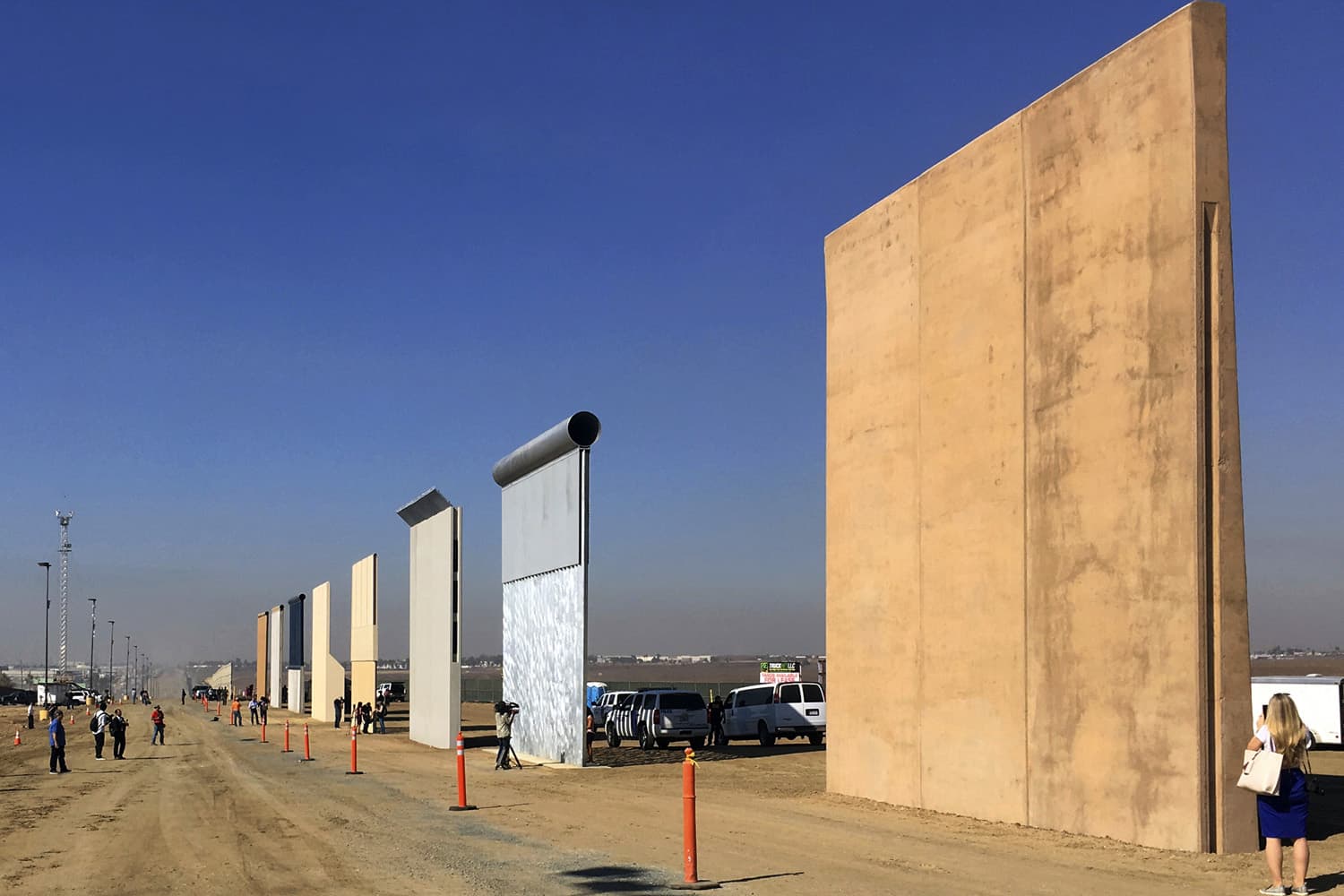 FILE - This Oct. 26, 2017 file photo shows prototypes of border walls in San Diego. A federal judge in San Diego who was taunted by Donald Trump during the presidential campaign has sided with the president on a challenge to building a border wall with Mexico. U.S. District Judge Gonzalo Curiel on Tuesday, Feb. 27, 2018 rejected arguments by the state of California and advocacy groups that the administration overreached by waiving laws requiring environmental and other reviews before construction could begin. (AP Photo/Elliott Spagat, File)