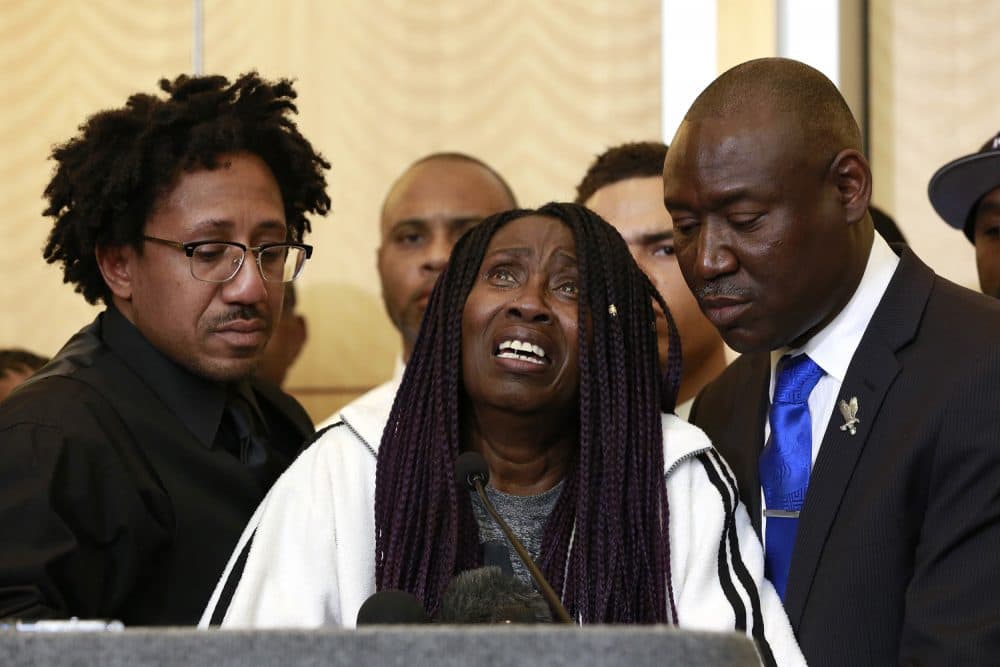A tearful Sequita Thompson, center, pauses as she discusses the shooting of her grandson, Stephon Clark, during a news conference, Monday, March 26, 2018, in Sacramento, Calif. Clark, who was unarmed, was shot and killed by Sacramento police officers who were responding to a call about person smashing car windows a week ago. Thompson was accompanied by Clark's uncle, Kurtis Gordon, left, and attorney Ben Crump, right. (AP Photo/Rich Pedroncelli)