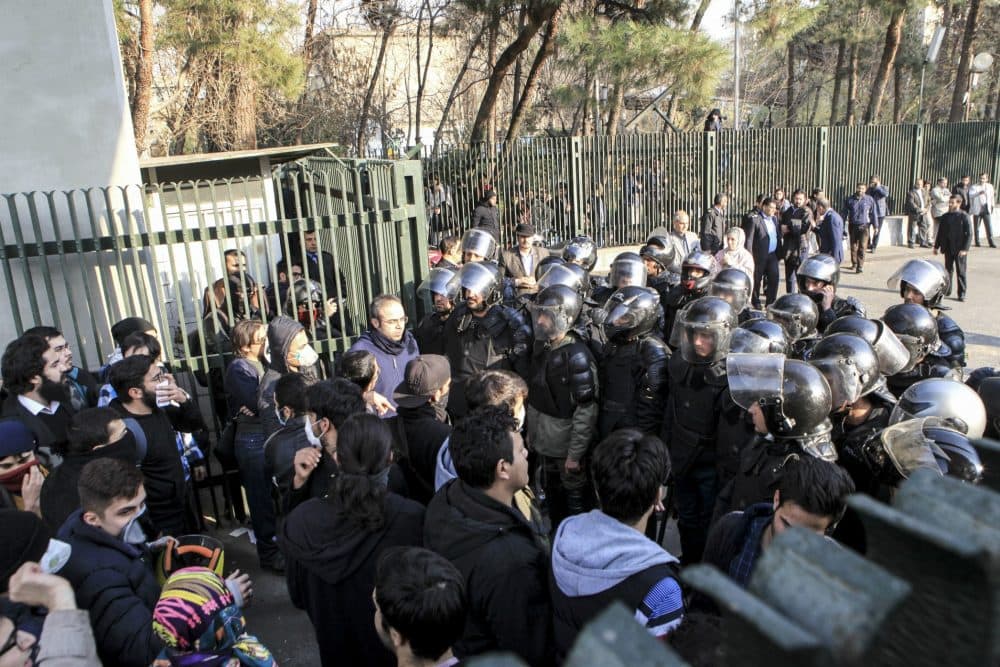 In this photo taken by an individual not employed by the Associated Press and obtained by the AP outside Iran, anti-riot Iranian police prevent university students to join other protesters over Iran weak economy, in Tehran, Iran, Saturday, Dec. 30, 2017. (AP)