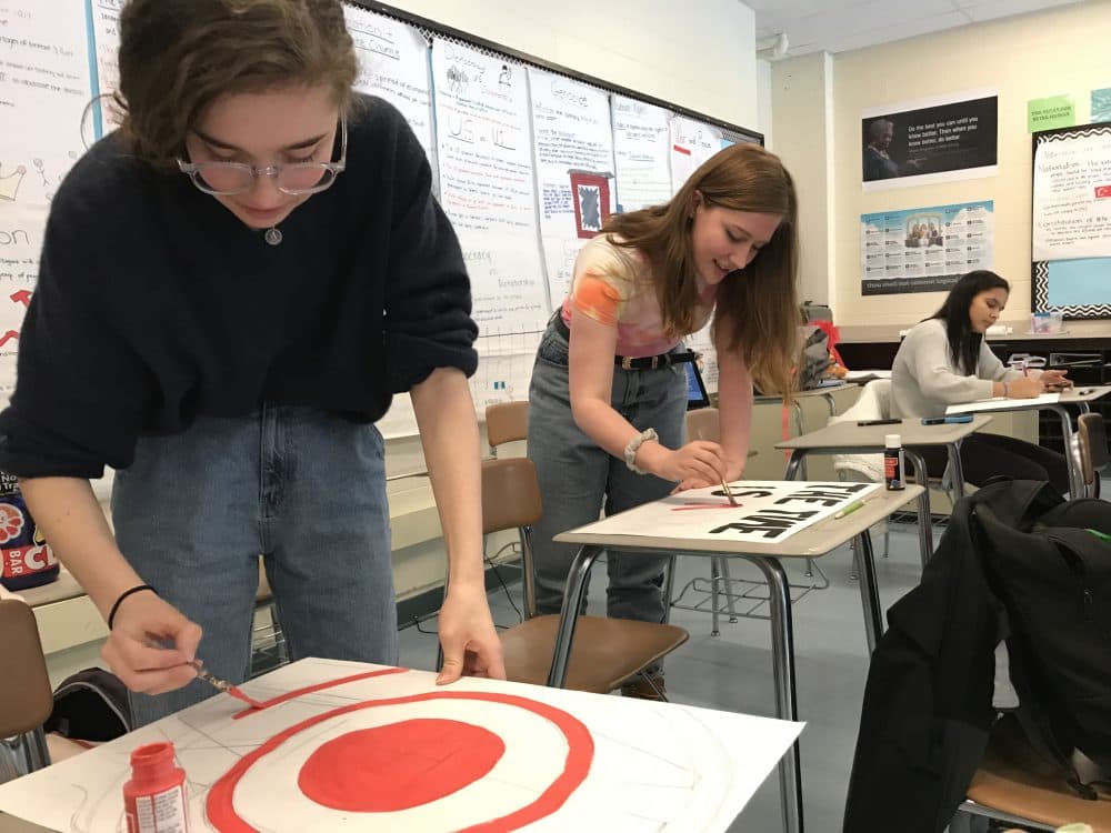 Andover High School Students make posters ahead of Wednesday's walk out. (Carrie Jung/WBUR)