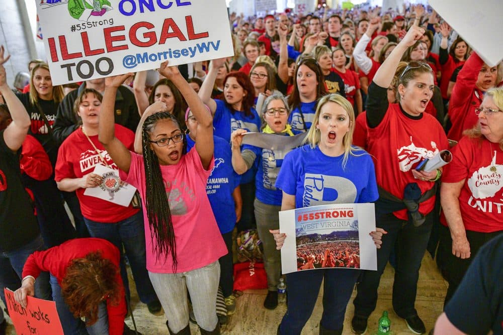 Teachers hold a rally outside the Senate Chambers in the West Virginia Capitol Monday, March. 5, 2018 in Charleston, W.V. Hundreds of teachers from 55 counties are on strike for pay raises and better health benefits,  (AP Photo/Tyler Evert)