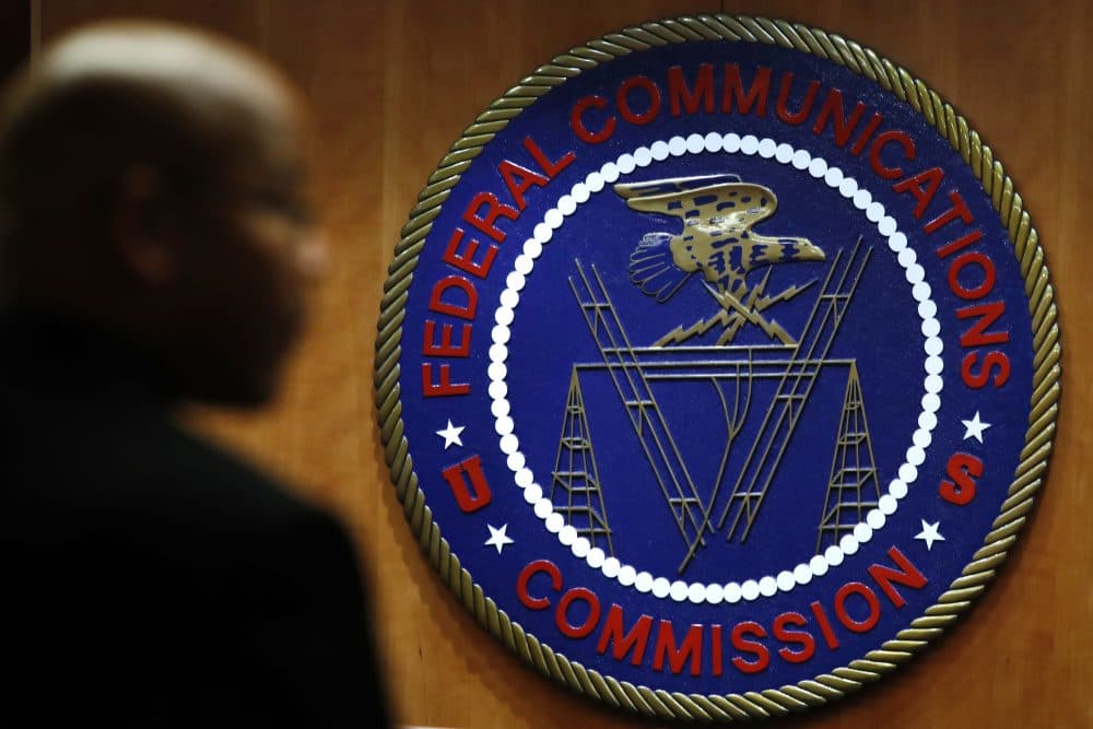 This Thursday, Dec. 14, 2017, photo, shows the seal of the Federal Communications Commission before a meeting in Washington. (AP Photo/Jacquelyn Martin)