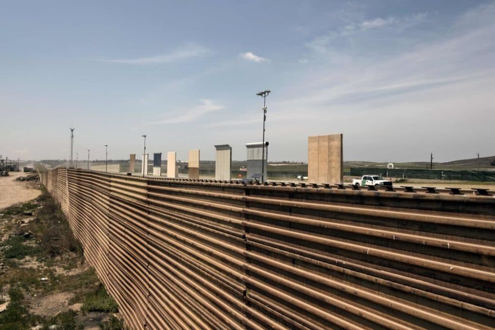 A U.S. border patrol truck is seen next to President Trump's border wall prototypes at the U.S.-Mexico border in Tijuana, Mexico, on April 3, 2018. Trump on Tuesday vowed to deploy the military to secure the southern border of the U.S. as a caravan of Central American migrants heads north through Mexico toward the United States. (Guillermo Arias/AFP/Getty Images)