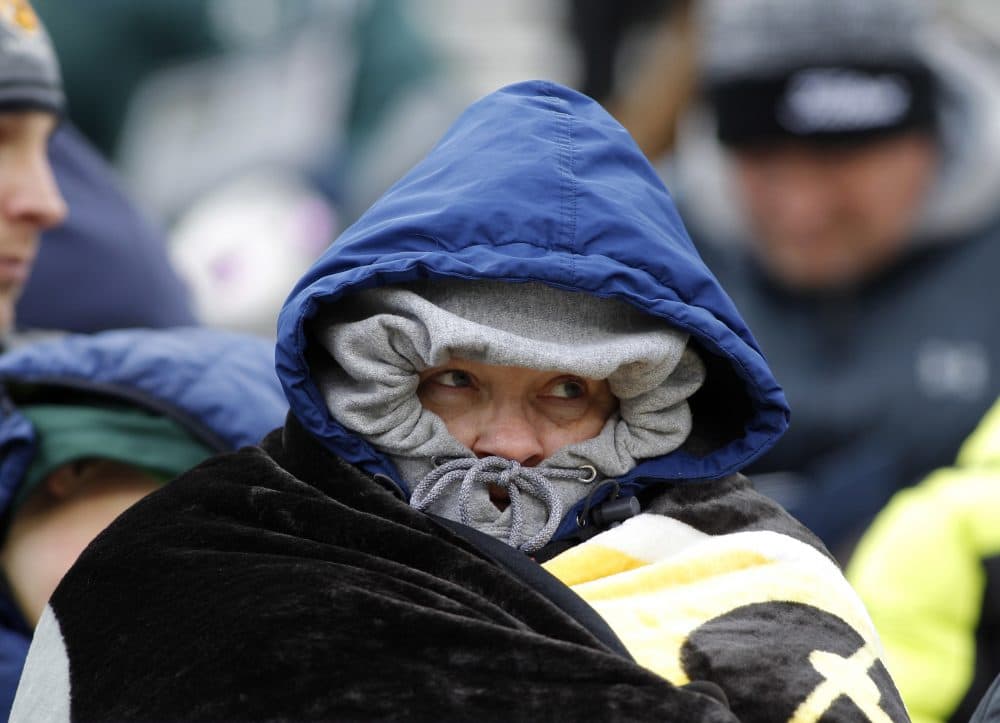 A Michigan State fan bundles up in the cold before an NCAA college football scrimmage, Saturday, April 7, 2018, in East Lansing, Mich. (Al Goldis/AP)