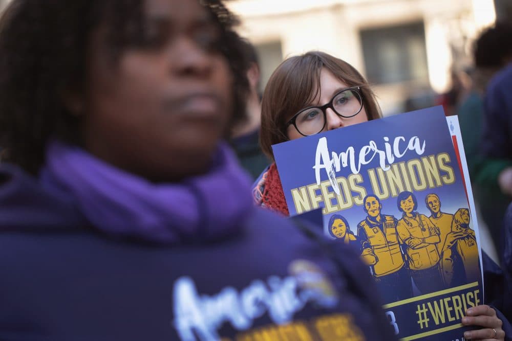 Members of the Service Employees International Union (SEIU) hold a rally in support of the American Federation of State County and Municipal Employees (AFSCME) union at the Richard J. Daley Center plaza on Feb. 26, 2018 in Chicago, amid the U.S. Supreme Court hearing arguments in Janus v. AFSCME, a lawsuit that challenges unions' authority under state law to collect compulsory fees from all employees they serve. (Scott Olson/Getty Images)